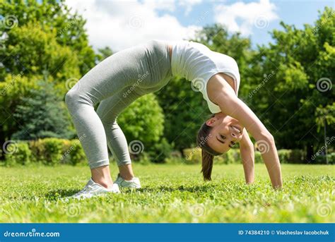 Positive Woman Standing In The Back Bend Position Stock Photo Image Of Athletic Daytime