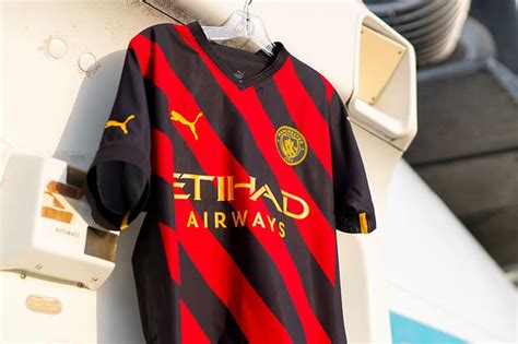 Manchester Citys 202223 Away Kit Arrives In Red And Black Stripes