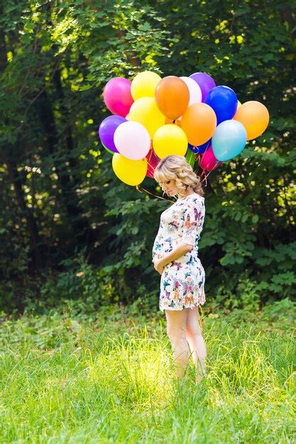 Premium Photo Pregnant Woman With Balloons Outdoors