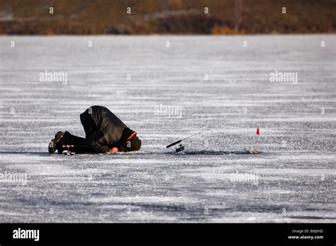 Ice Fisher On A Frozen Lake Stock Photo Alamy