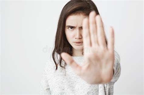 Studio Shot Of Attractive European Woman With Concerned Expression And