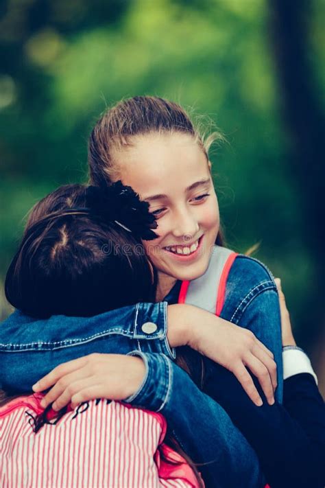 Two Happy School Friends Hugging Meet In The Park Stock Photo Image