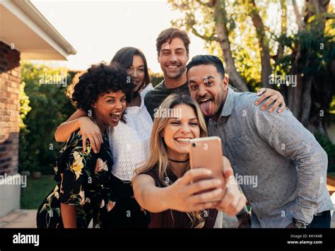 Group Of People Partying Together And Taking Selfie Young Friends At