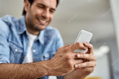 premium photo closeup of a an texting on mobile phone while relaxing at home