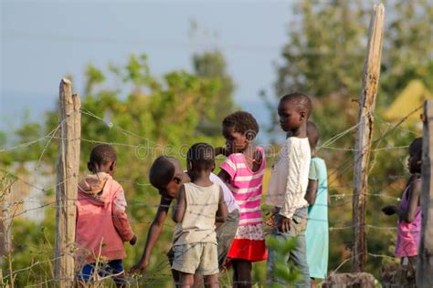 African Poor Children On The Street Near Fence Editorial Stock Photo