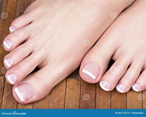 female feet with white french pedicure on nails at spa salon stock image image of beauty