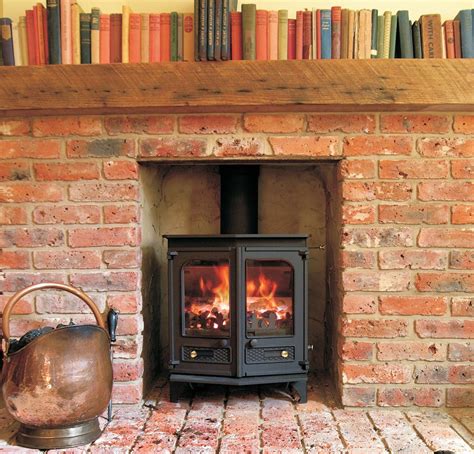The vent terminal is mounted outside and connects to the fireplace indoors. Brick fireplace with log burner | Brick hearth, Brick ...
