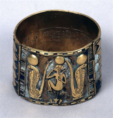 An Old Brass Bracelet With Designs On It