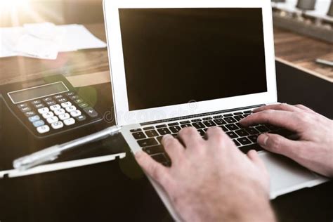 Person Sitting At Desk Working On Typing On Laptop Computer Stock Photo
