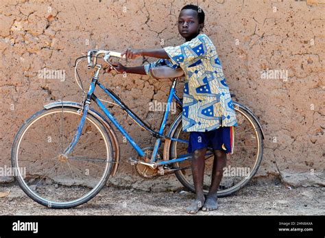 A Burkinabe Boy Standing By His Bicycle In A Small Village In Central