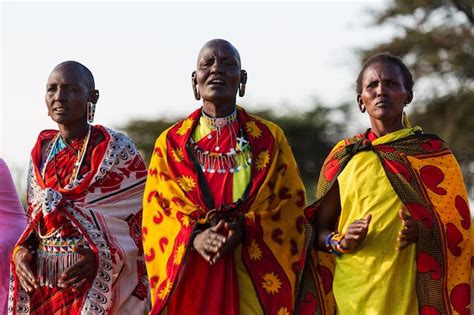 premium photo masai woman in traditional clothes with holes in their ears dancing and singing