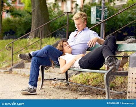 Man Looking At His Girlfriend Resting On His Lap Stock Photography
