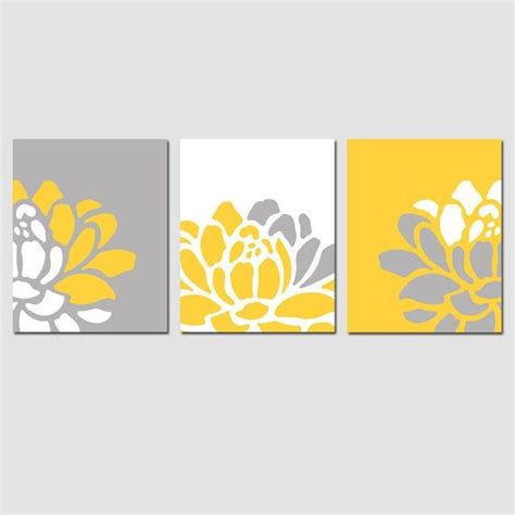 Three Yellow And Gray Flower Paintings On The Wall