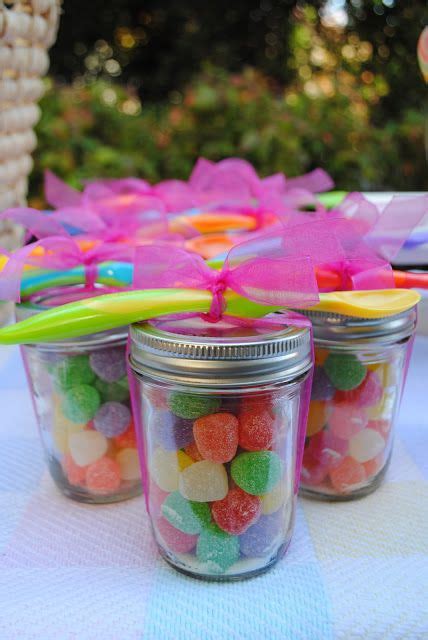Three Jars Filled With Candy Sitting On Top Of A Table