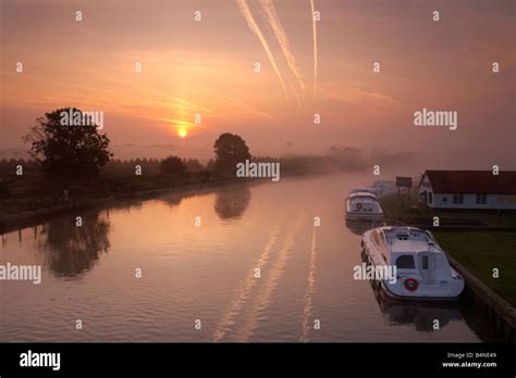 The River Bure At Sunrise On A Misty Morning Viewed From Acle Bridge On