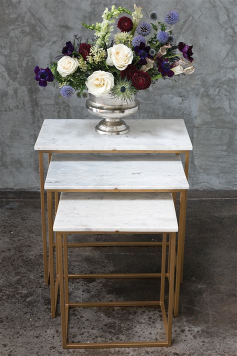 The steel frames are finished in a gold powder coating and paired with a clear glass top. Hemingway Marble Nesting Tables - Moss Manor