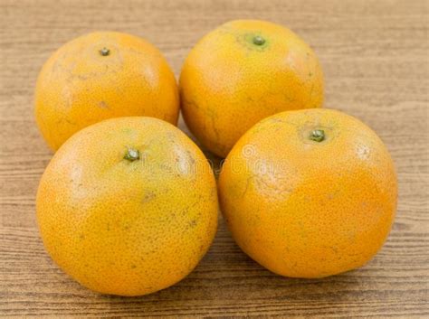 Four Ripe Oranges On A Wooden Table Stock Photo Image Of Orange