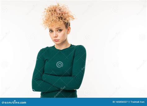 Attractive Sad Curly Blonde Girl With Arms Crossed On A White