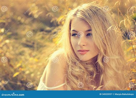 Portrait Of A Blonde Girl In A Stylish Jacket On The Background Of A Waterfall The Concept Of