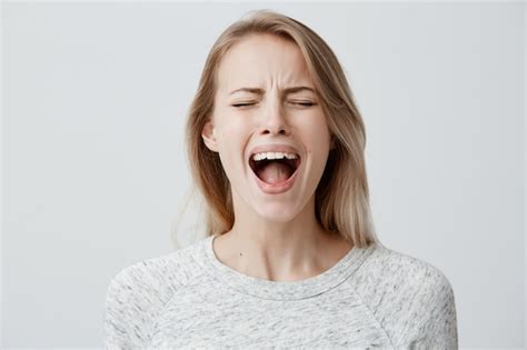 Free Photo Emotional Blonde Woman Opening Her Mouth Widely Screaming