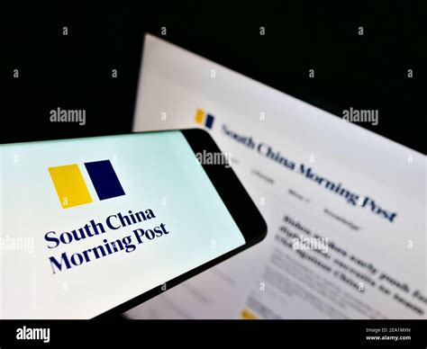 Mobile Phone With Logo Of Newspaper South China Morning Post Hongkong On Screen In Front Of