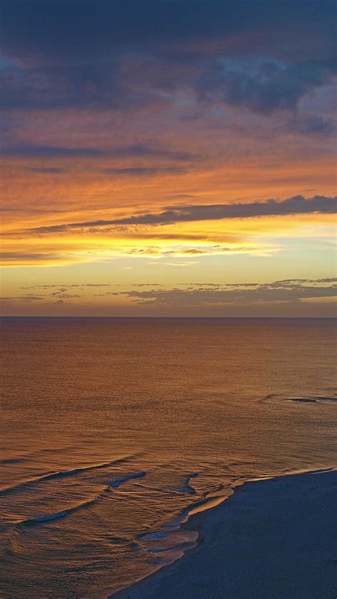 Download Wallpaper 720x1280 Beach Sunset Calm Sea Clouds Sky