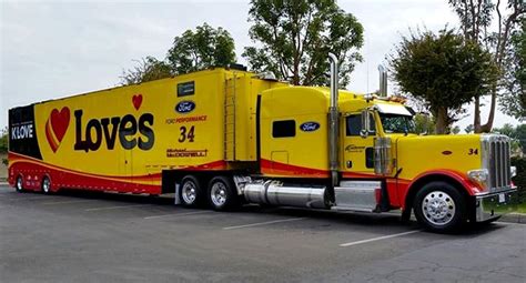 A Large Yellow Semi Truck Parked In A Parking Lot