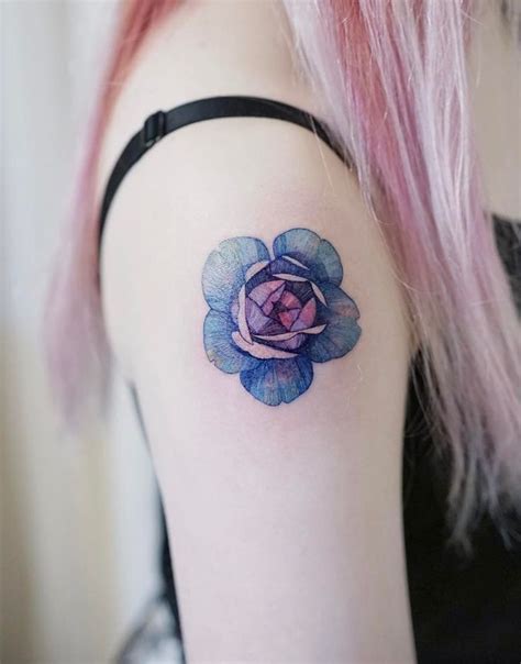 A Woman With Pink Hair Has A Tattoo On Her Arm