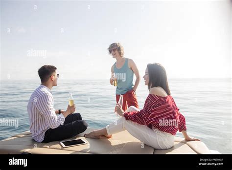 Yacht Drinking Beers While Talking Group Of Friends Having Party On