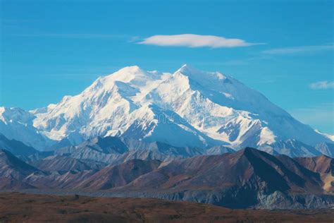 Snow Covered Denali Mountain In Alaska With Cloud Floating Above The
