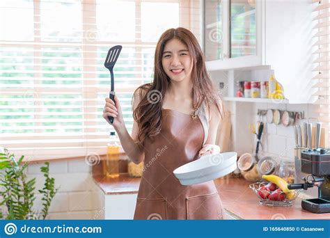 Asian Woman Chef Cook Or Housewife Preparing Food In Kitchen Cooking