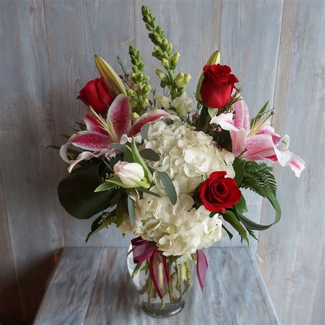Vase Arrangement Of White Hydrangea Snap Dragons Ecuadorian Red Roses