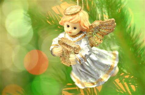 Using promo codes on appliances connection. Figure Of Little Angel Playing The Harp Against Bokeh ...