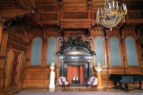 An Ornately Decorated Room With Chandelier And Piano