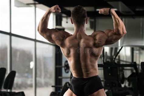Muscular Man Flexing Back Muscles Pose Stock Photo Image Of Indoors