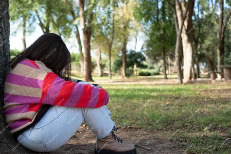 Premium Photo Unhappy Woman Sitting Alone On The Ground In A Park Thinking About Problems