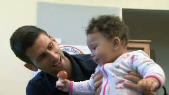 Could their kids be next in line? Novak Djokovic plays with a child - ABC News (Australian Broadcasting Corporation)