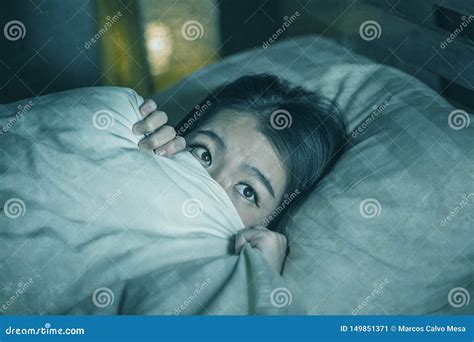 Young Sleepless Beautiful And Scared Asian Japanese Woman Lying On Bed