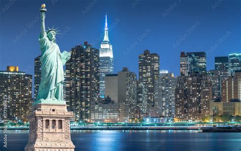The Statue Of Liberty With Cityscape In Manhattan At Night New York