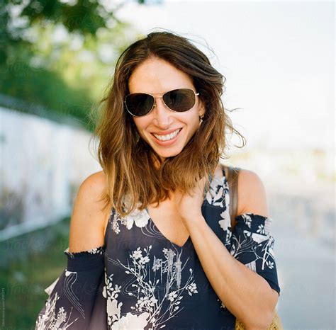 Portrait Of A Smiling Beautiful Woman Wearing Sunglasses Del Colaborador De Stocksy Jakob