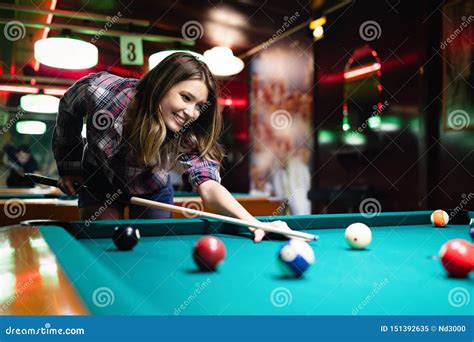 Young Beautiful Woman Having Fun And Playing Billiard In A Club Stock