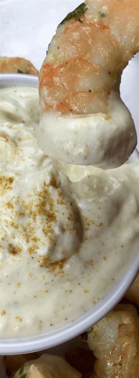 A White Plate Topped With Food And Dipping Sauce