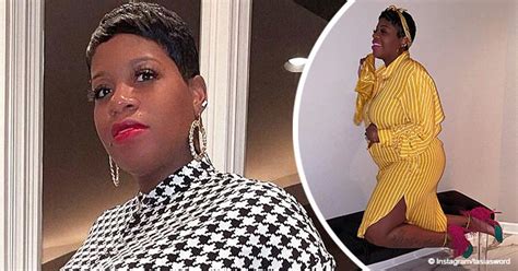 pregnant fantasia cradles her belly posing in striped yellow outfit and pink feathered high heels