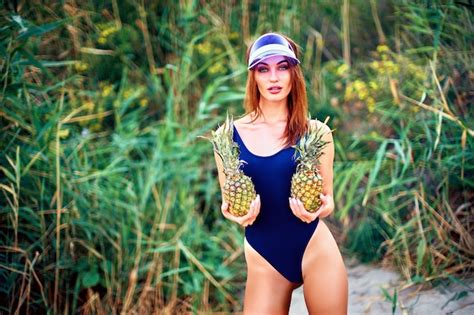 Premium Photo Skinny Model In Swimsuit Posing With Pineapples