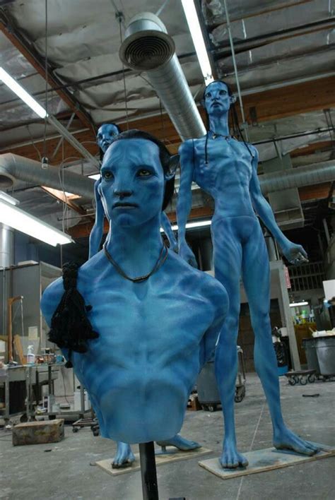 Two Blue Mannequins Are Standing Next To Each Other In An Industrial Area