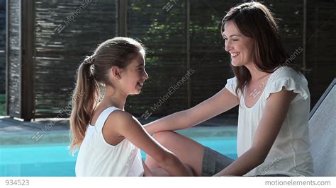 Mother And Daughter Talking By Swimming Pool Stock Video Footage 934523