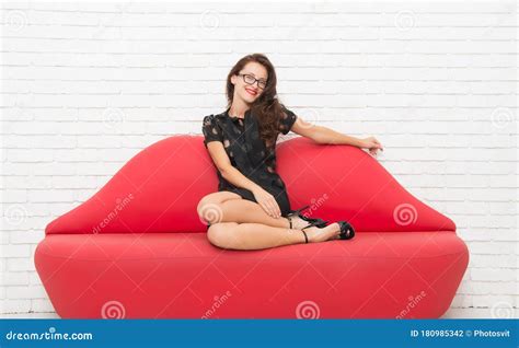 My New Lifestyle Positive Brunette Woman Sitting On Red Leather Couch Beauty Relaxing On Sofa