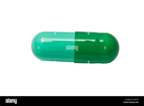 Green capsule isolated on white background Stock Photo - Alamy