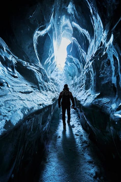Man Exploring An Amazing Glacial Ice Cave Stock Photo Image Of Blue