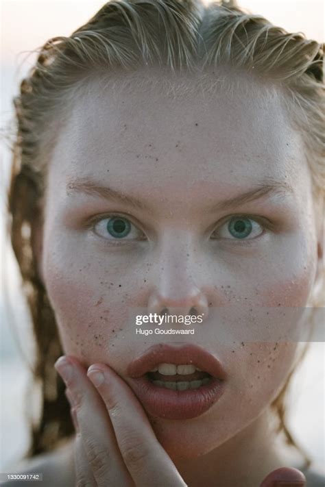 Plus Size Model Looking Into The Lens Wet Hair Closeup On The Beach